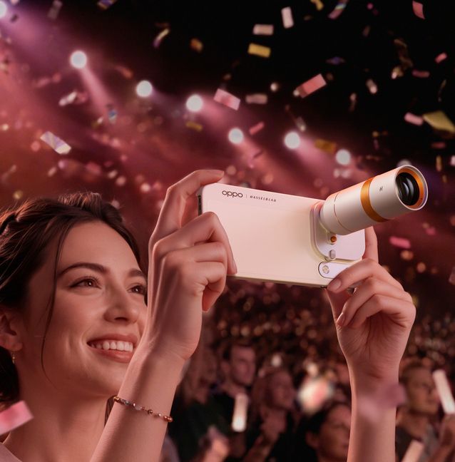 Hands hold an OPPO Find X10 Pro Max with a large Hasselblad Teleconverter Kit mounted to its camera