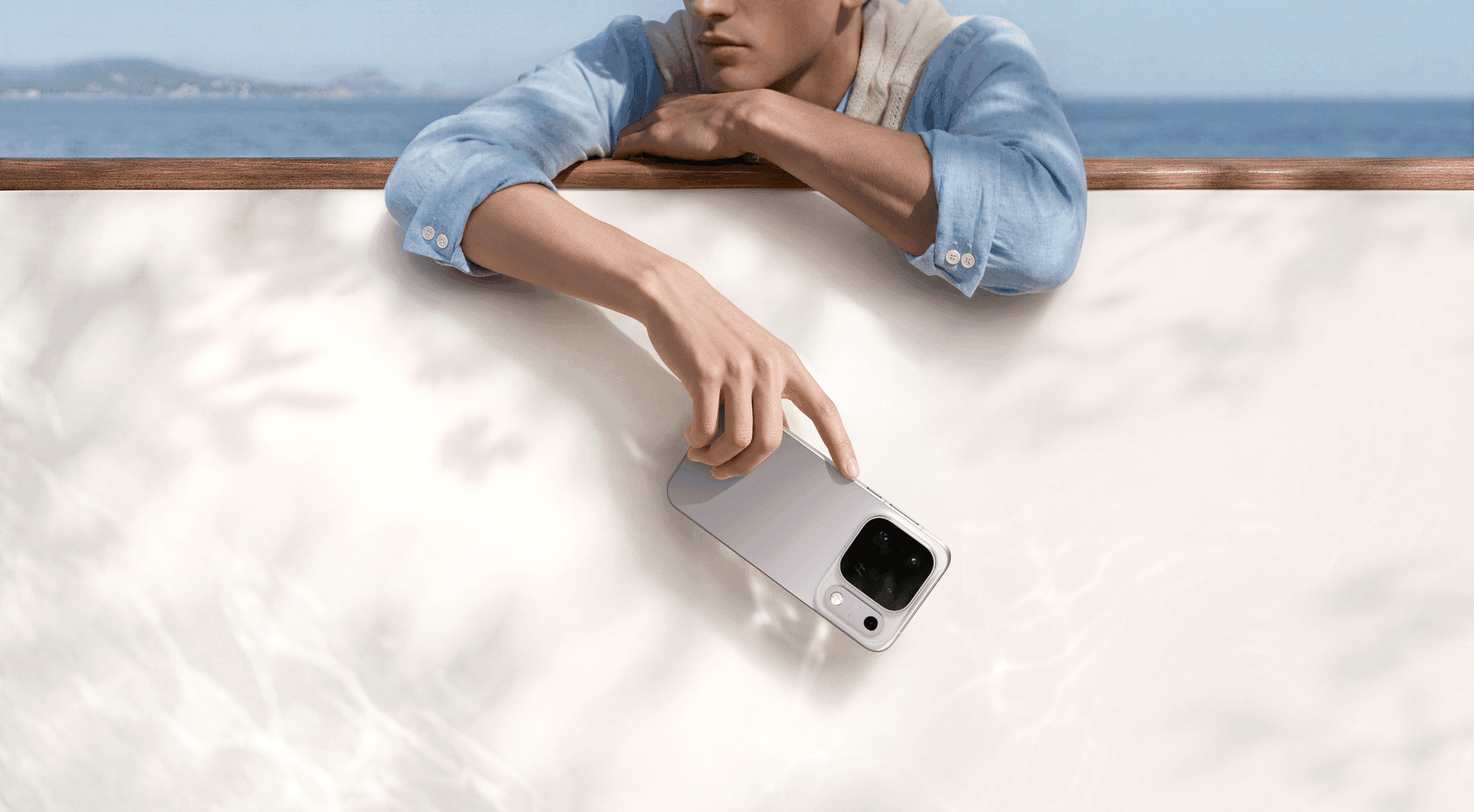 A Man holding OPPO Find X10 Pro Max (Titanium Grey) held close to a marble railing, showcasing its elegant finish