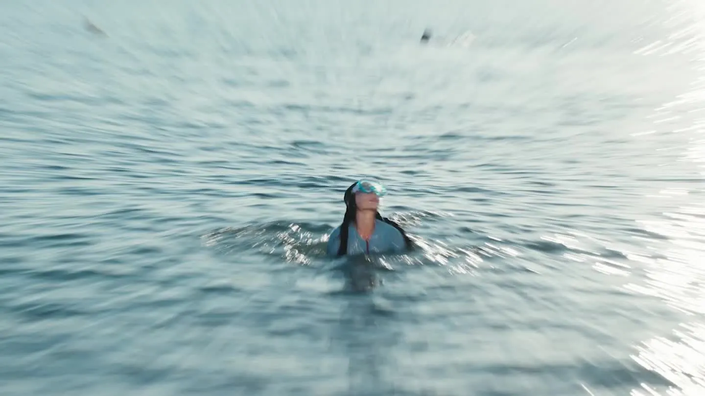Distant swimmer in the sea, shot via Hasselblad 200MP Ultra-Sensing Telephoto Camera.