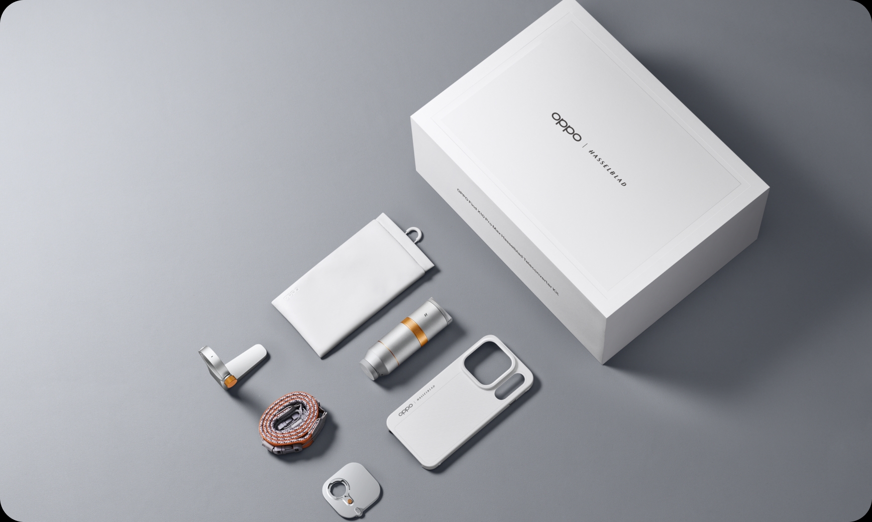 Flat lay display of the OPPO Hasselblad Teleconverter Kit with lens, case, strap, and box