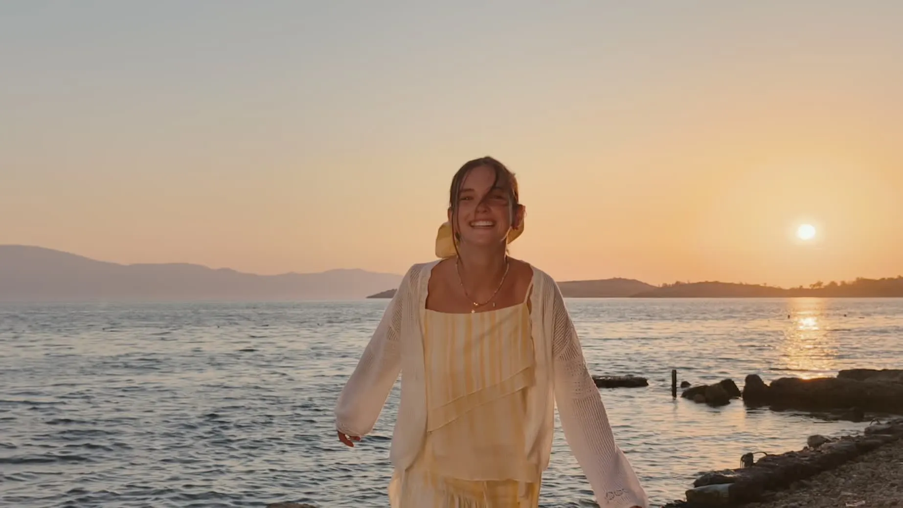 Cinematic HDR video of a woman on a beach at sunset