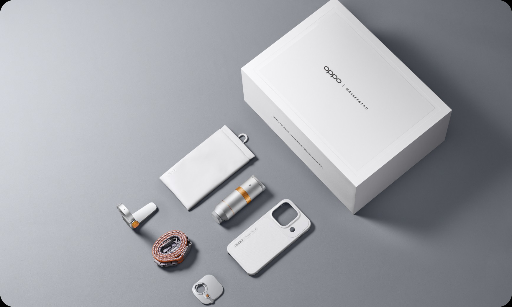Flat lay display of the OPPO Hasselblad Teleconverter Kit with lens, case, strap, and box