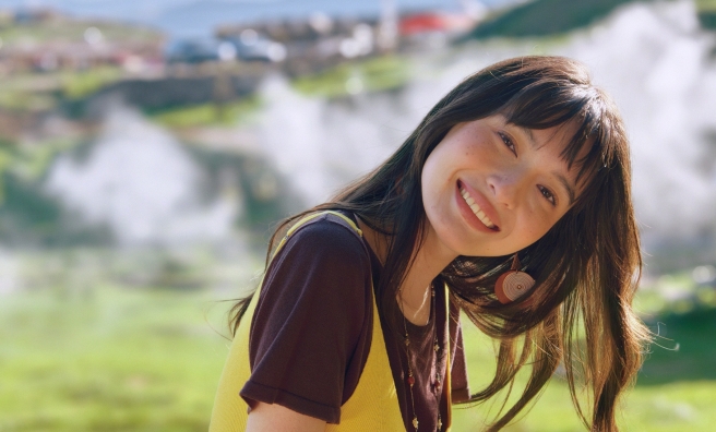 Hasselblad portrait of a woman in a yellow vest against a mountain backdrop