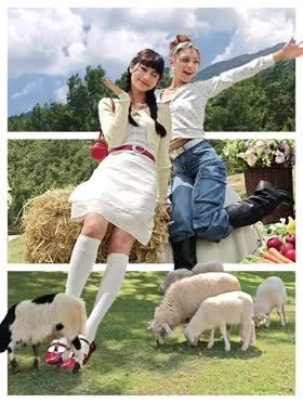 A photo showing the Popout 2.0 effect, where two girls and sheep break out of horizontal white borders to create a 3D look